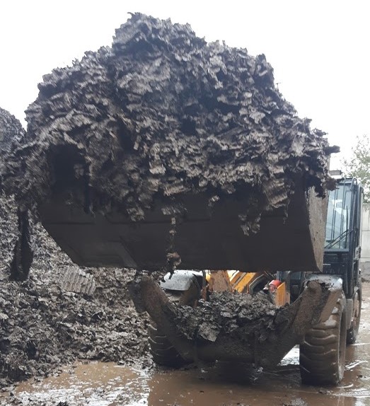 Telehandler bucket full of waste plastic media